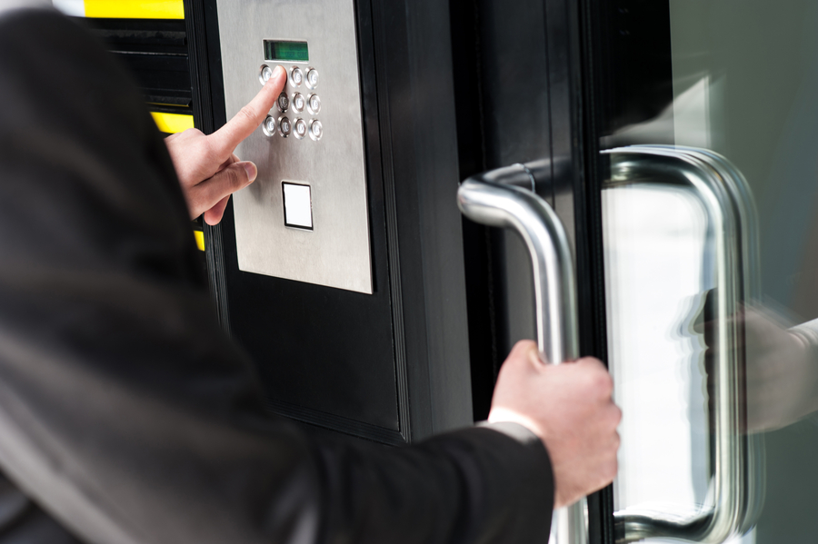 person attempting to access a door using a keypad entry system.