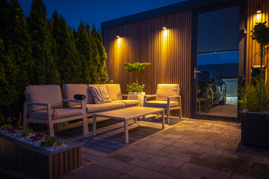 A patio seating area illuminated with warm outdoor lighting.